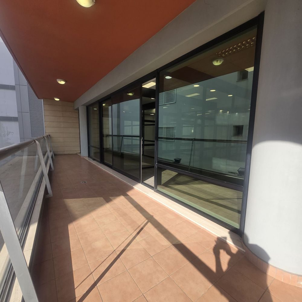 Clean floor-to-ceiling glass doors on a balcony